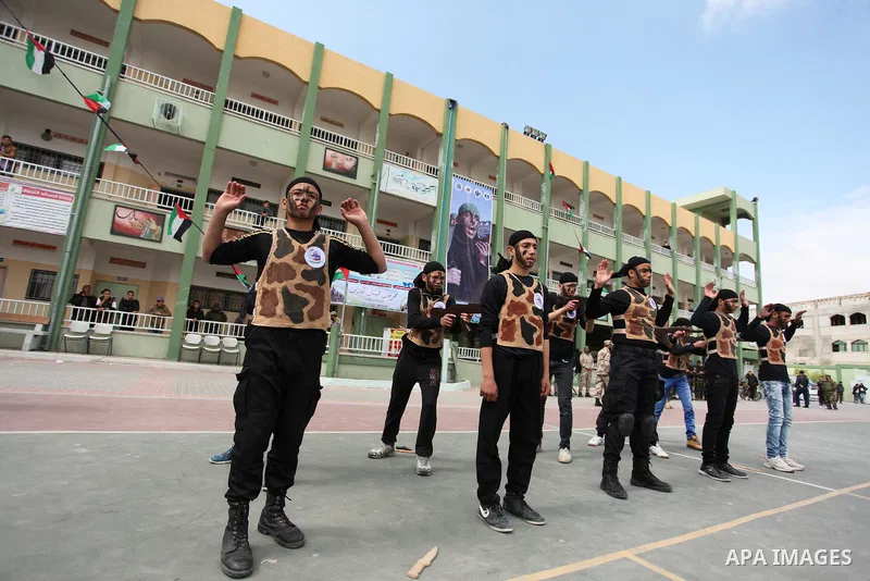 Palestinian students demonstrate their skills during a military-style show at a school in Rafah in the southern Gaza Strip March 28, 2016. Photo by Ashraf Amra