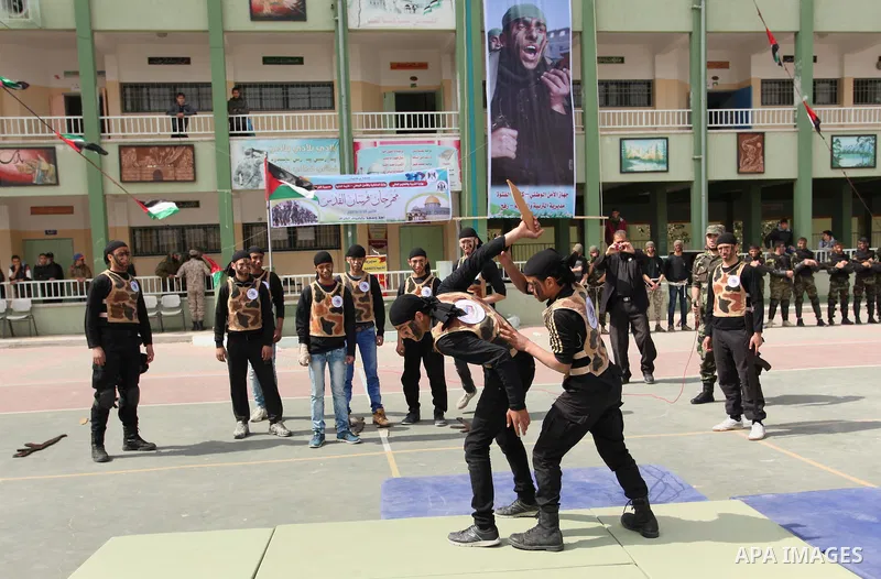 Palestinian students demonstrate their skills during a military-style show at a school in Rafah in the southern Gaza Strip March 28, 2016. Photo by Ashraf Amra