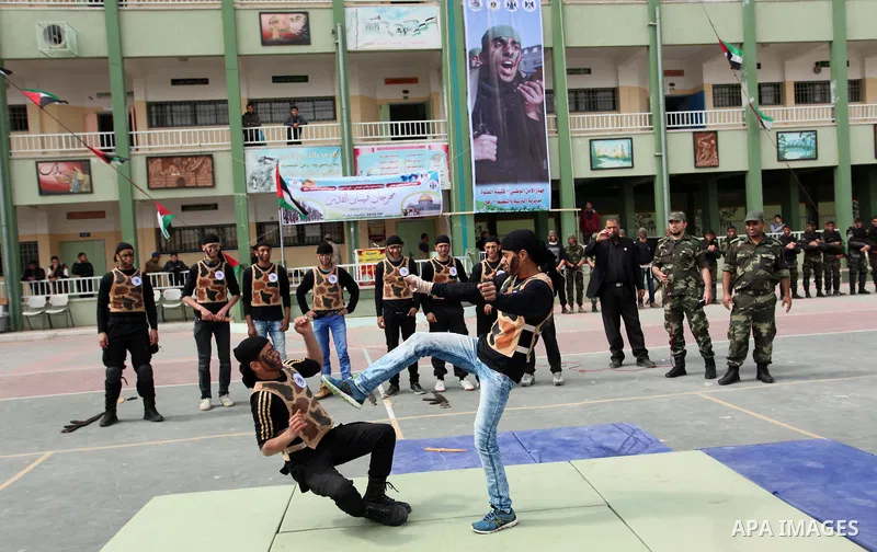 Palestinian students demonstrate their skills during a military-style show at a school in Rafah in the southern Gaza Strip March 28, 2016. Photo by Ashraf Amra