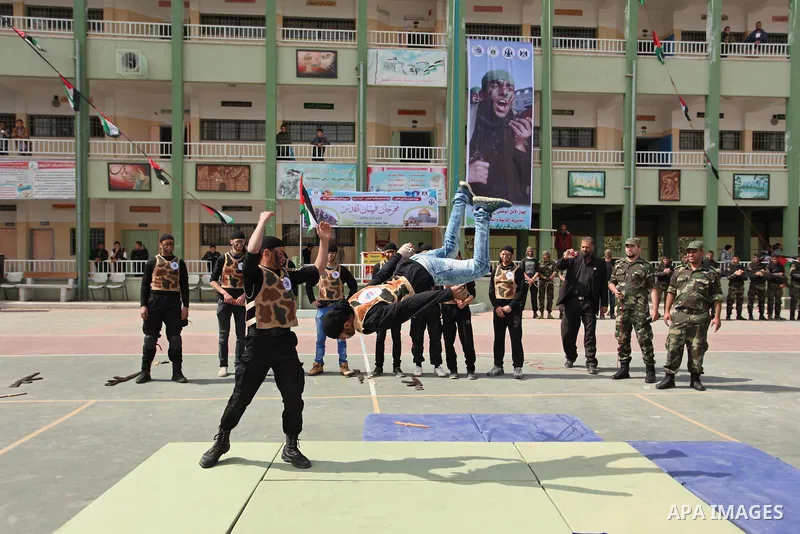 Palestinian students demonstrate their skills during a military-style show at a school in Rafah in the southern Gaza Strip March 28, 2016. Photo by Ashraf Amra