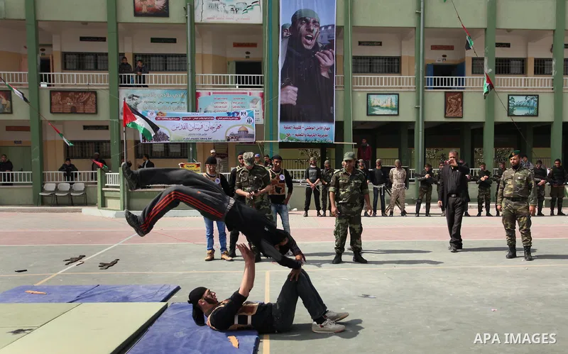 Palestinian students demonstrate their skills during a military-style show at a school in Rafah in the southern Gaza Strip March 28, 2016. Photo by Ashraf Amra