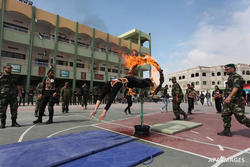Palestinian students demonstrate their skills during a military-style show at a school in Rafah in the southern Gaza Strip March 28, 2016. Photo by Ashraf Amra