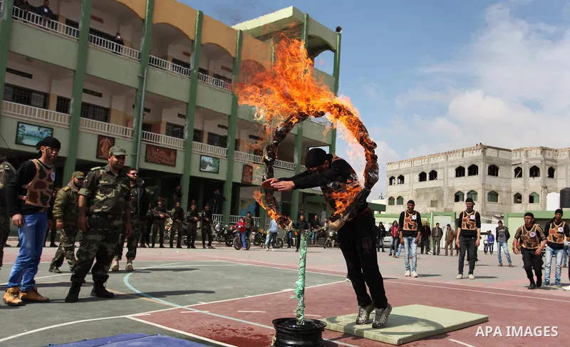 Palestinian students demonstrate their skills during a military-style show at a school in Rafah in the southern Gaza Strip March 28, 2016. Photo by Ashraf Amra