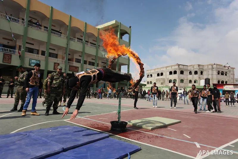 Palestinian students demonstrate their skills during a military-style show at a school in Rafah in the southern Gaza Strip March 28, 2016. Photo by Ashraf Amra