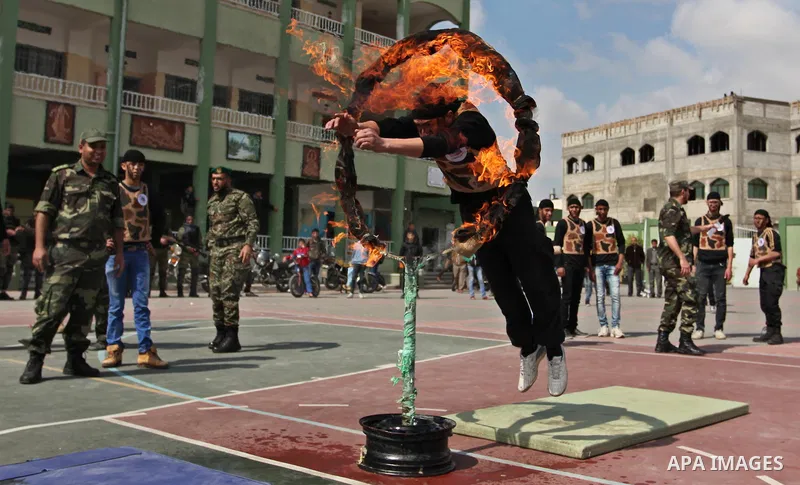 Palestinian students demonstrate their skills during a military-style show at a school in Rafah in the southern Gaza Strip March 28, 2016. Photo by Ashraf Amra