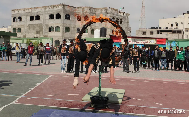 Palestinian students demonstrate their skills during a military-style show at a school in Rafah in the southern Gaza Strip March 28, 2016. Photo by Ashraf Amra