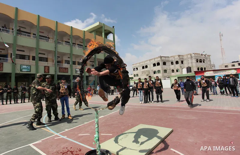Palestinian students demonstrate their skills during a military-style show at a school in Rafah in the southern Gaza Strip March 28, 2016. Photo by Ashraf Amra
