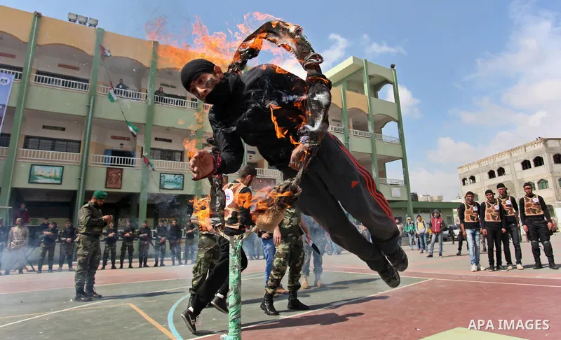 Palestinian students demonstrate their skills during a military-style show at a school in Rafah in the southern Gaza Strip March 28, 2016. Photo by Ashraf Amra