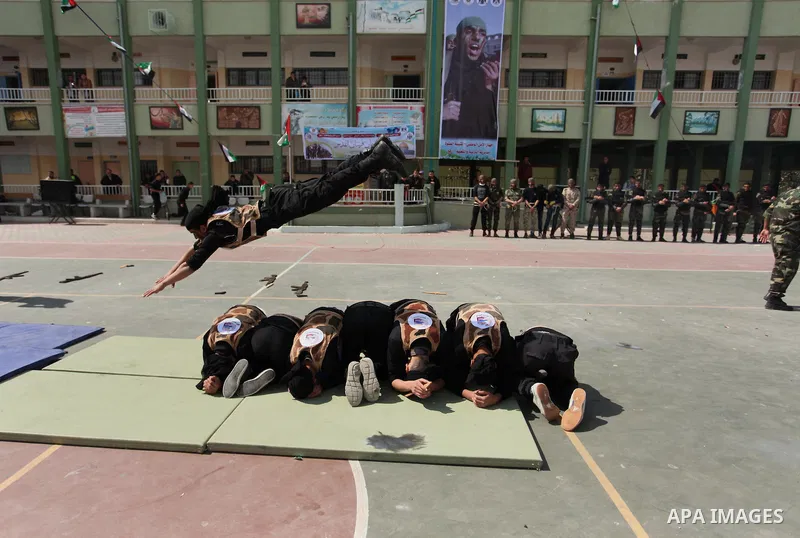 Palestinian students demonstrate their skills during a military-style show at a school in Rafah in the southern Gaza Strip March 28, 2016. Photo by Ashraf Amra