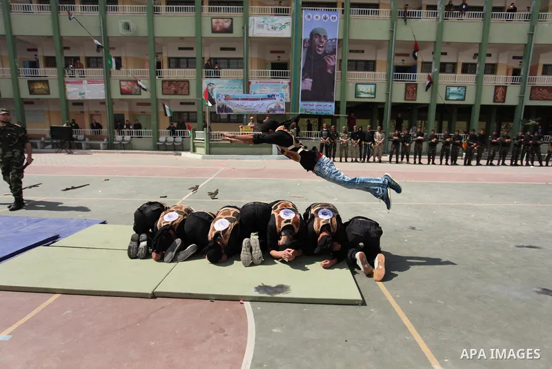 Palestinian students demonstrate their skills during a military-style show at a school in Rafah in the southern Gaza Strip March 28, 2016. Photo by Ashraf Amra