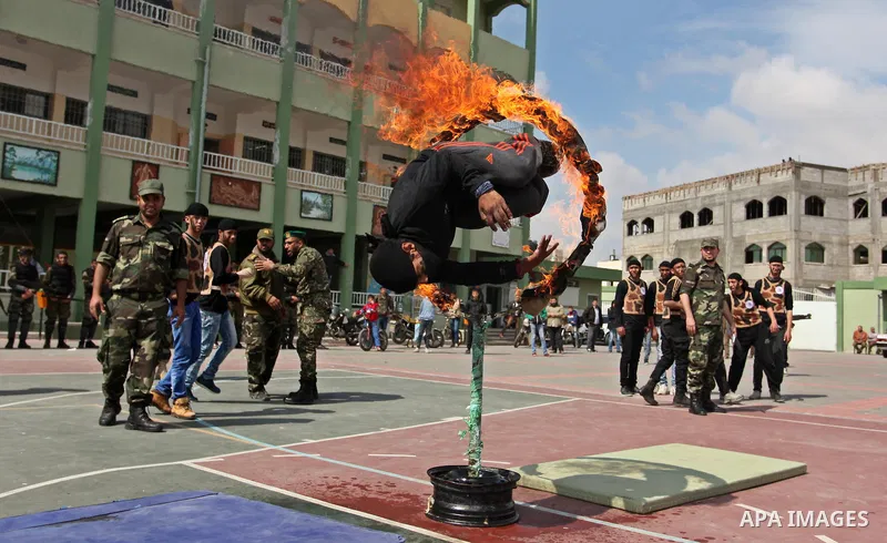 Palestinian students demonstrate their skills during a military-style show at a school in Rafah in the southern Gaza Strip March 28, 2016. Photo by Ashraf Amra