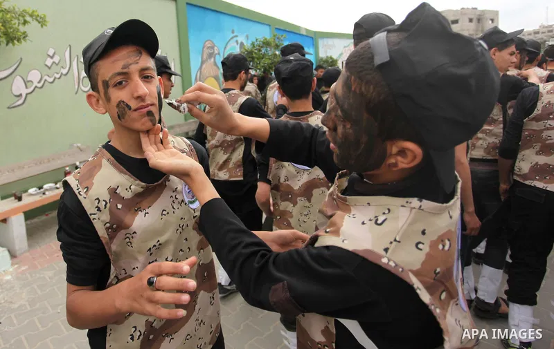 Palestinian students demonstrate their skills during a military-style show at a school in Rafah in the southern Gaza Strip March 28, 2016. Photo by Ashraf Amra