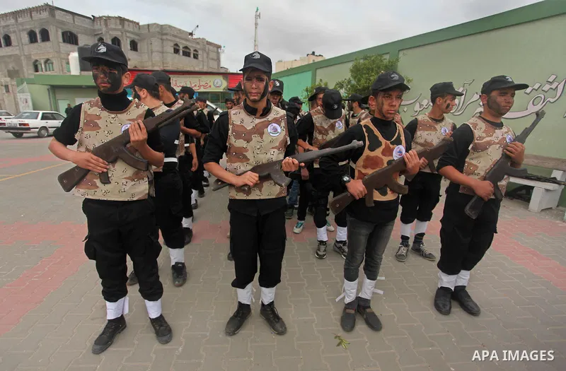 Palestinian students demonstrate their skills during a military-style show at a school in Rafah in the southern Gaza Strip March 28, 2016. Photo by Ashraf Amra
