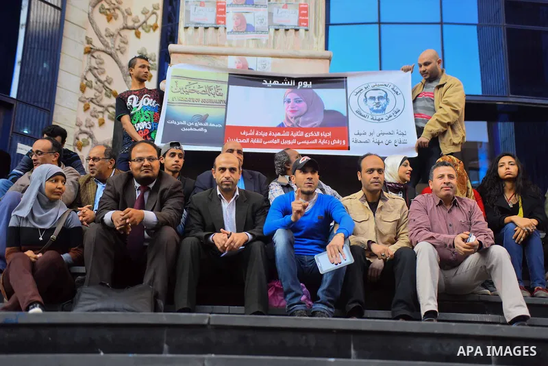 Egyptian journalists light candles during a protest the death of the Egyptian journalist Mayada Ashraf, outside the Egyptian Journalist Syndicate in Cairo, on March 28, 2016. Al-Dustour, a privately-owned newspaper, said...