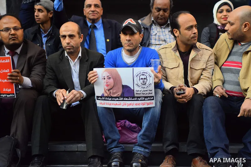 Egyptian journalists light candles during a protest the death of the Egyptian journalist Mayada Ashraf, outside the Egyptian Journalist Syndicate in Cairo, on March 28, 2016. Al-Dustour, a privately-owned newspaper, said...