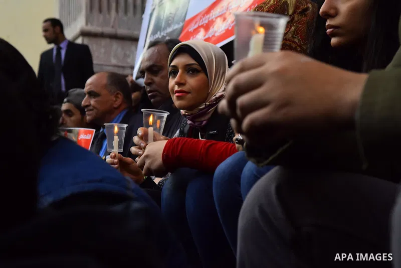 Egyptian journalists light candles during a protest the death of the Egyptian journalist Mayada Ashraf, outside the Egyptian Journalist Syndicate in Cairo, on March 28, 2016. Al-Dustour, a privately-owned newspaper, said...