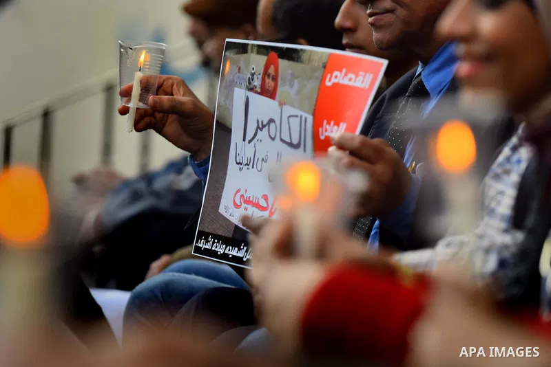 Egyptian journalists light candles during a protest the death of the Egyptian journalist Mayada Ashraf, outside the Egyptian Journalist Syndicate in Cairo, on March 28, 2016. Al-Dustour, a privately-owned newspaper, said...
