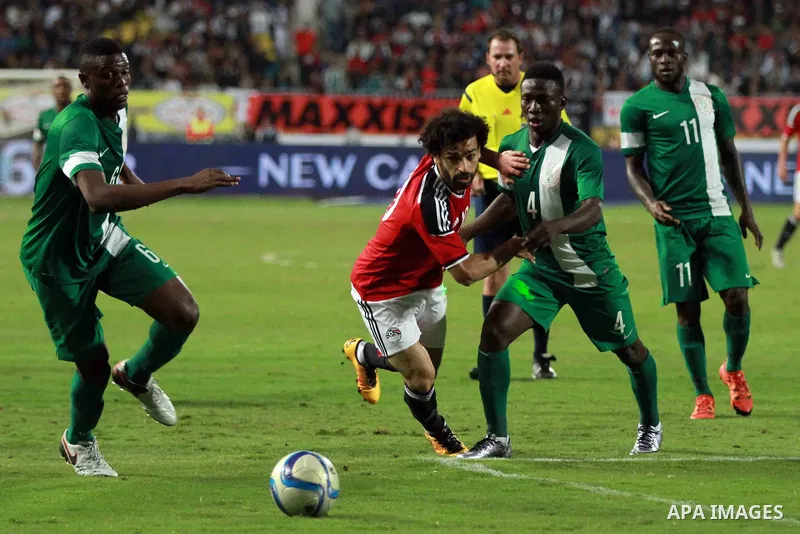 Egyptian players and Nigerian players compete during their African Cup of Nations group G qualification football match between Egypt and Nigeria at the Borg el-Arab Stadium in Alexandria on March 29, 2016. Photo by Strin...