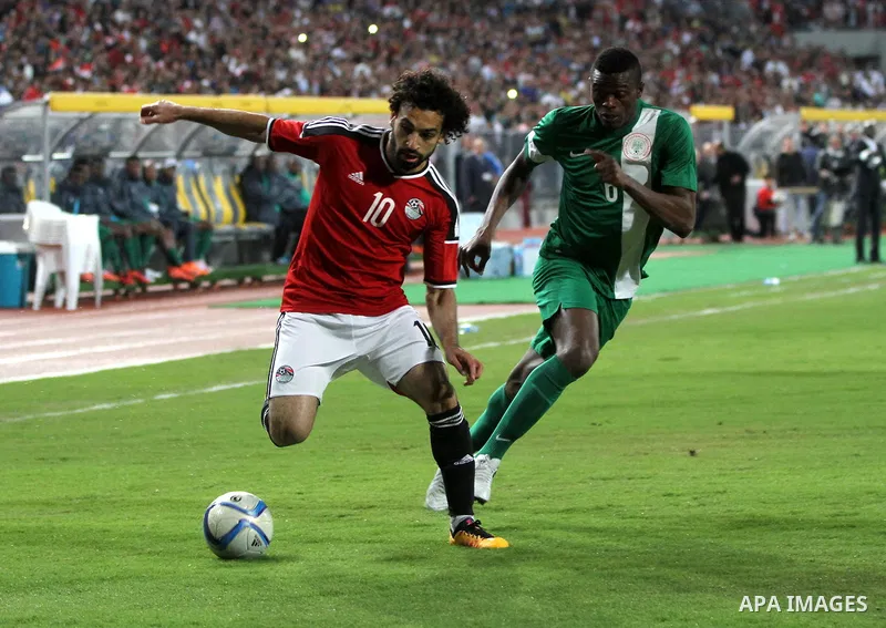 Egyptian players and Nigerian players compete during their African Cup of Nations group G qualification football match between Egypt and Nigeria at the Borg el-Arab Stadium in Alexandria on March 29, 2016. Photo by Strin...