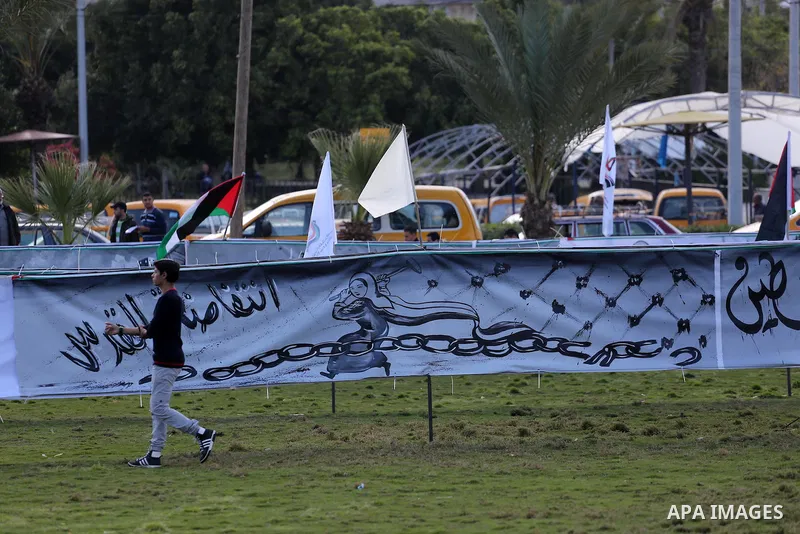 A Palestinian man walks past a mural during a rally marking Land Day, in Gaza City March 30, 2016. March 30 marks Land Day, the annual commemorations of the killing by police of six Arab citizens in 1976 during protests...