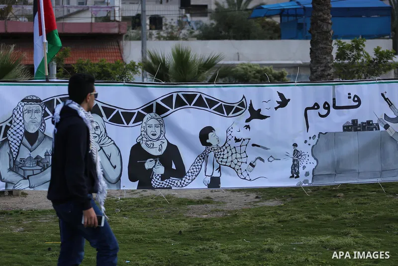A Palestinian man walks past a mural during a rally marking Land Day, in Gaza City March 30, 2016. March 30 marks Land Day, the annual commemorations of the killing by police of six Arab citizens in 1976 during protests...