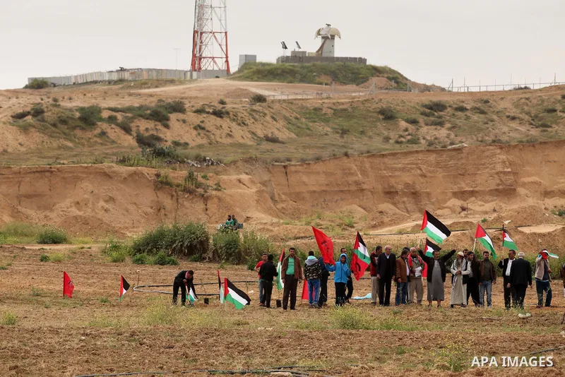 Demonstrators holding Palestinian flags chant slogans during a rally marking Land Day, near the Israeli border with central Gaza Strip March 30, 2016. March 30 marks Land Day, the annual commemorations of the killing by...