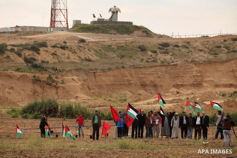 Demonstrators holding Palestinian flags chant slogans during a rally marking Land Day, near the Israeli border with central Gaza Strip March 30, 2016. March 30 marks Land Day, the annual commemorations of the killing by...