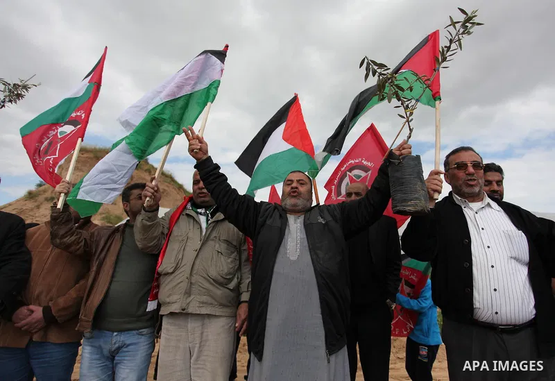 Demonstrators holding Palestinian flags chant slogans during a rally marking Land Day, near the Israeli border with central Gaza Strip March 30, 2016. March 30 marks Land Day, the annual commemorations of the killing by...