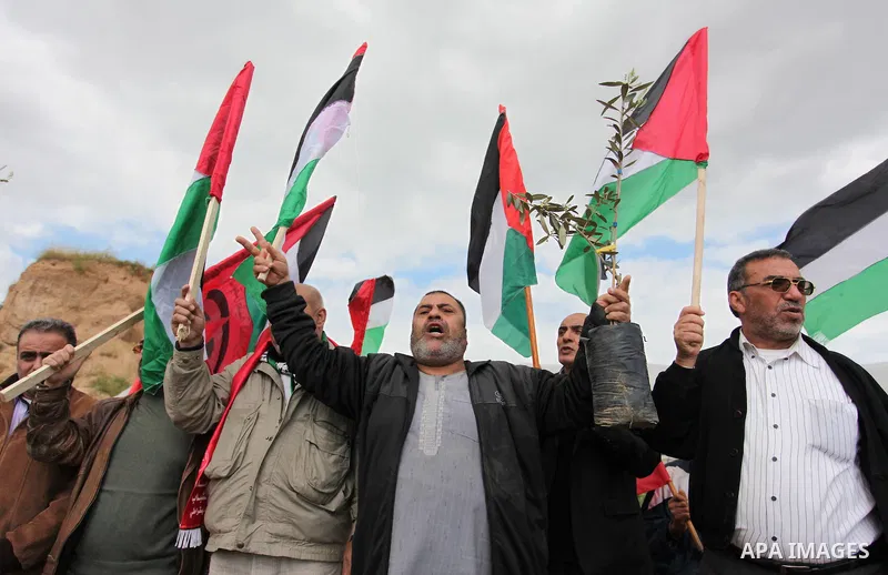 Demonstrators holding Palestinian flags chant slogans during a rally marking Land Day, near the Israeli border with central Gaza Strip March 30, 2016. March 30 marks Land Day, the annual commemorations of the killing by...