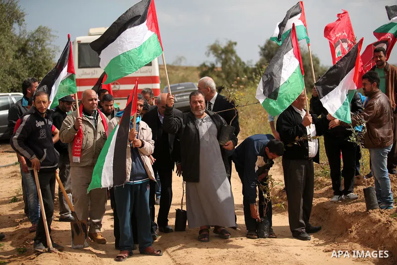 Demonstrators holding Palestinian flags chant slogans during a rally marking Land Day, near the Israeli border with central Gaza Strip March 30, 2016. March 30 marks Land Day, the annual commemorations of the killing by...