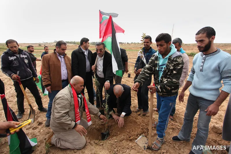 Demonstrators holding Palestinian flags chant slogans during a rally marking Land Day, near the Israeli border with central Gaza Strip March 30, 2016. March 30 marks Land Day, the annual commemorations of the killing by...