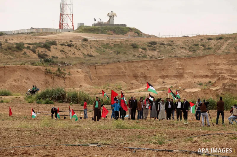 Demonstrators holding Palestinian flags chant slogans during a rally marking Land Day, near the Israeli border with central Gaza Strip March 30, 2016. March 30 marks Land Day, the annual commemorations of the killing by...