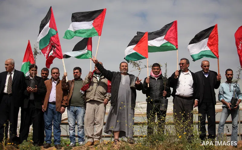 Demonstrators holding Palestinian flags chant slogans during a rally marking Land Day, near the Israeli border with central Gaza Strip March 30, 2016. March 30 marks Land Day, the annual commemorations of the killing by...