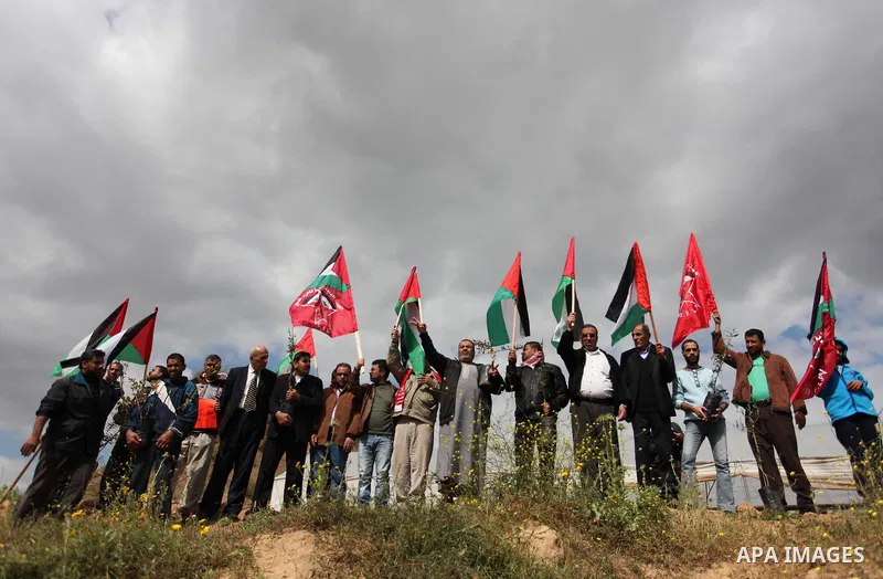 Demonstrators holding Palestinian flags chant slogans during a rally marking Land Day, near the Israeli border with central Gaza Strip March 30, 2016. March 30 marks Land Day, the annual commemorations of the killing by...