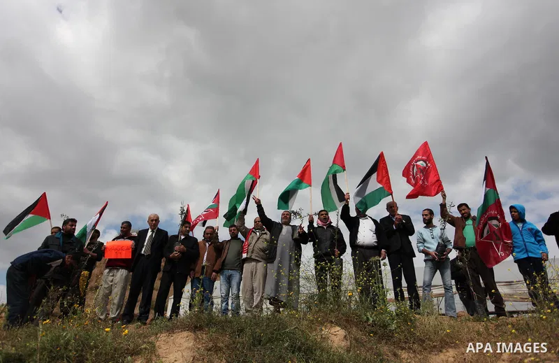 Demonstrators holding Palestinian flags chant slogans during a rally marking Land Day, near the Israeli border with central Gaza Strip March 30, 2016. March 30 marks Land Day, the annual commemorations of the killing by...