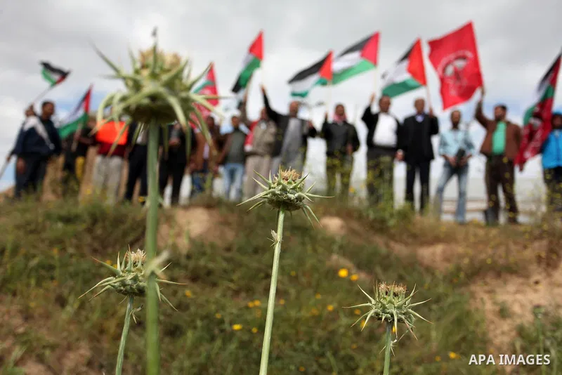 Demonstrators holding Palestinian flags chant slogans during a rally marking Land Day, near the Israeli border with central Gaza Strip March 30, 2016. March 30 marks Land Day, the annual commemorations of the killing by...