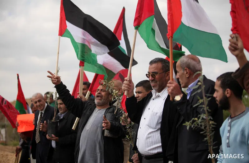 Demonstrators holding Palestinian flags chant slogans during a rally marking Land Day, near the Israeli border with central Gaza Strip March 30, 2016. March 30 marks Land Day, the annual commemorations of the killing by...