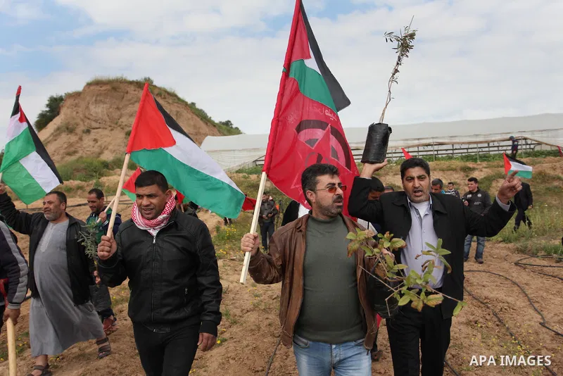Demonstrators holding Palestinian flags chant slogans during a rally marking Land Day, near the Israeli border with central Gaza Strip March 30, 2016. March 30 marks Land Day, the annual commemorations of the killing by...