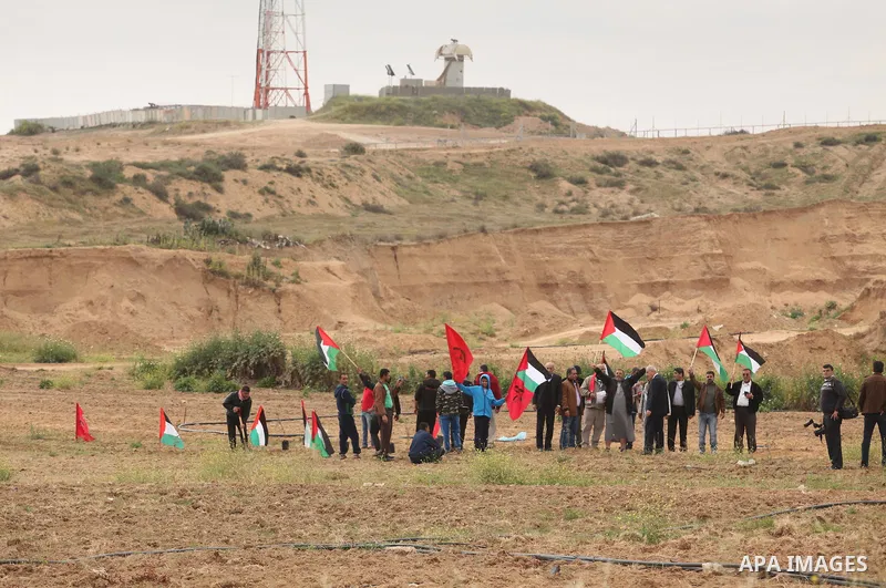 Demonstrators holding Palestinian flags chant slogans during a rally marking Land Day, near the Israeli border with central Gaza Strip March 30, 2016. March 30 marks Land Day, the annual commemorations of the killing by...