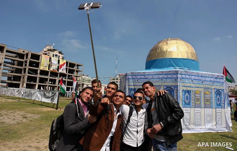 Palestinian youths take a selfie in front of a model depicting the Dome of the Rock during a rally marking Land Day, in Gaza City March 30, 2016. March 30 marks Land Day, the annual commemorations of the killing by polic...