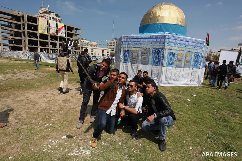 Palestinian youths take a selfie in front of a model depicting the Dome of the Rock during a rally marking Land Day, in Gaza City March 30, 2016. March 30 marks Land Day, the annual commemorations of the killing by polic...