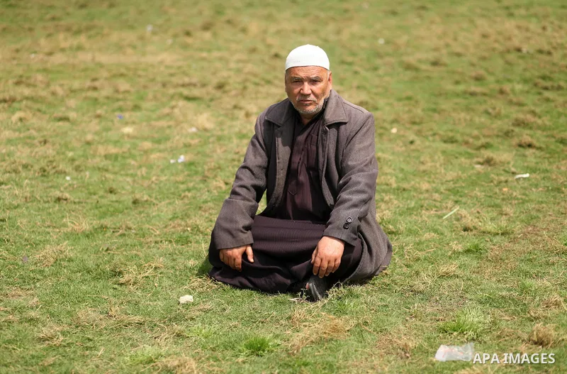 A Palestinian man sits on a land during a rally marking Land Day, in Gaza City March 30, 2016. March 30 marks Land Day, the annual commemorations of the killing by police of six Arab citizens in 1976 during protests agai...