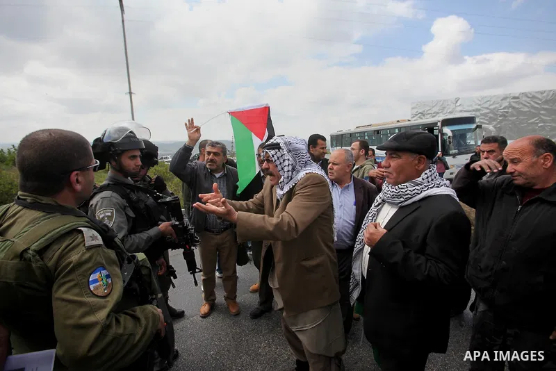 A Palestinian man argues with Israeli sceurity forces during clashes following a rally marking Land Day in the West Bank village of Burqa near Nablus on March 30, 2016. March 30 marks Land Day, the annual commemorations...