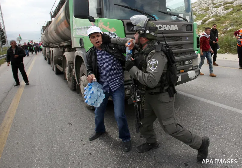 Israeli security forces clash with Palestinians as they disperse them during clashes following a rally marking Land Day in the West Bank village of Burqa near Nablus on March 30, 2016. March 30 marks Land Day, the annual...