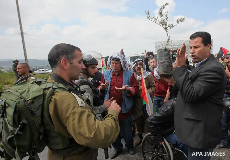 A Palestinian man argues with Israeli sceurity forces during clashes following a rally marking Land Day in the West Bank village of Burqa near Nablus on March 30, 2016. March 30 marks Land Day, the annual commemorations...