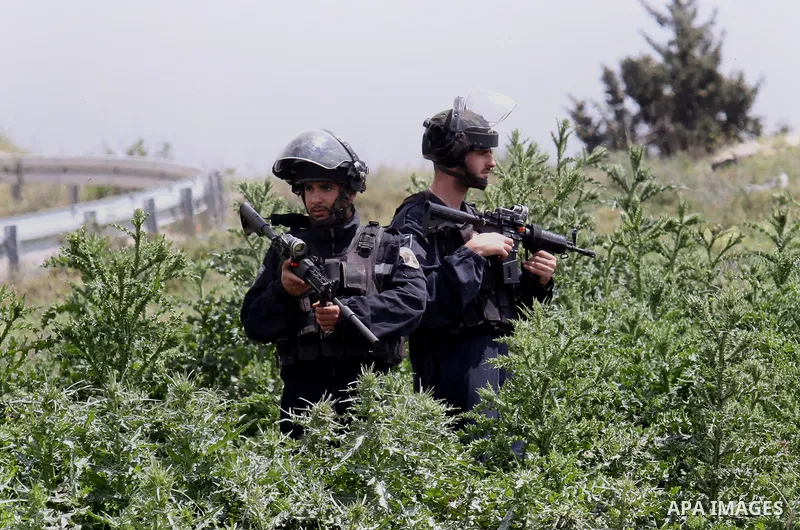 Israeli security froces take position during clashes with Palestinian demonstrators following a rally marking Land Day in the West Bank village of Burqa near Nablus on March 30, 2016. March 30 marks Land Day, the annual...