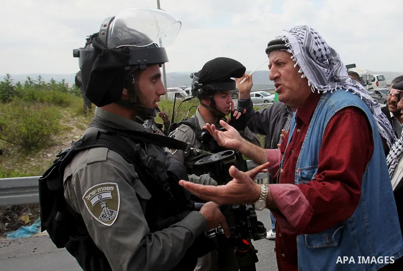 A Palestinian man argues with Israeli sceurity forces during clashes following a rally marking Land Day in the West Bank village of Burqa near Nablus on March 30, 2016. March 30 marks Land Day, the annual commemorations...