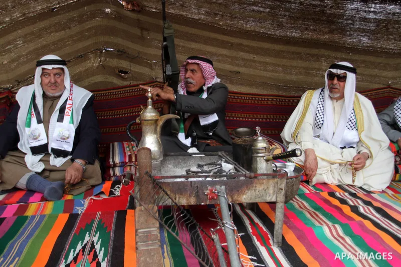 Palestinian men gather in a tent to mark Land Day on March 30, 2016, in Khan Yunis, in the southern Gaza Strip, as Palestinians mark Land Day. March 30 marks Land Day, the annual commemorations of the killing by police o...