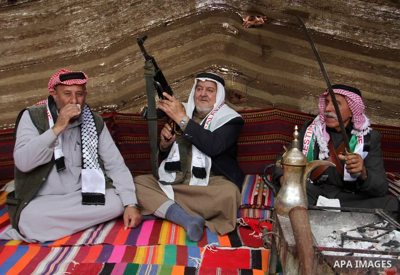 Palestinian men gather in a tent to mark Land Day on March 30, 2016, in Khan Yunis, in the southern Gaza Strip, as Palestinians mark Land Day. March 30 marks Land Day, the annual commemorations of the killing by police o...
