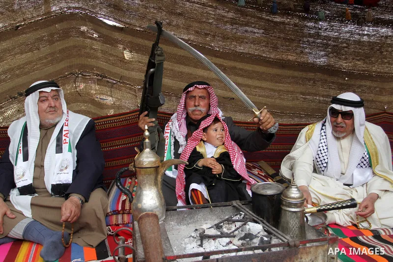 Palestinian men gather in a tent to mark Land Day on March 30, 2016, in Khan Yunis, in the southern Gaza Strip, as Palestinians mark Land Day. March 30 marks Land Day, the annual commemorations of the killing by police o...